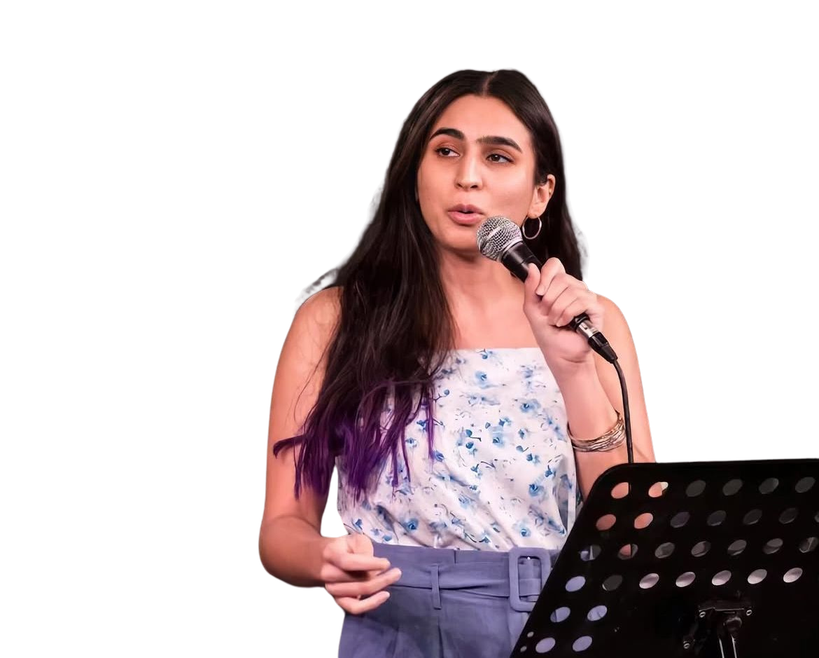Raveena Grover speaking into a microphone on stage